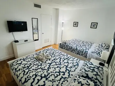 a bedroom with two beds and a flat screen tv at Miami Hollywood Great 2 Bedroom 2 Bathroom with Intercostal View 001-22bvic in Hollywood