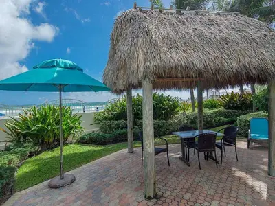 a patio with a table and a straw umbrella at Miami Hollywood Great 2 Bedroom 2 Bathroom with Intercostal View 001-22bvic in Hollywood
