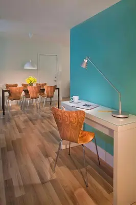 a living room with a desk and chairs and a table at 1818 Meridian House Apartments and Suites by Eskape Collection in Miami Beach