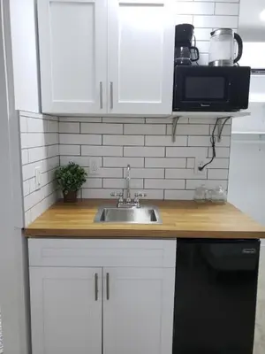 a kitchen counter with a sink and a microwave at Apts with Backyard Near Fort Lauderdale Beach, Nightlife, Cruise Port, Airport in Fort Lauderdale