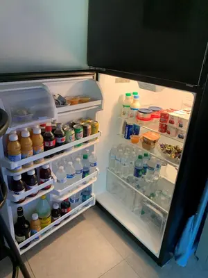 an open refrigerator filled with lots of food and drinks at Fantasy Island Inn, Caters to Men in Fort Lauderdale