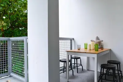 a table on a balcony with black stools at Amazing 2 BR Condo At Wynwood With Parking in Miami
