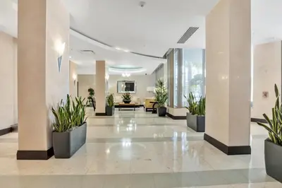 a lobby with potted plants in a building at The Tides Apartments on the beach in Hollywood