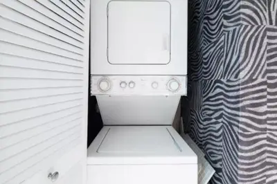 a small refrigerator with its door open in a room at Heart of South Beach / Modern Apartment / Ocean Drive - Carlyle in Miami Beach