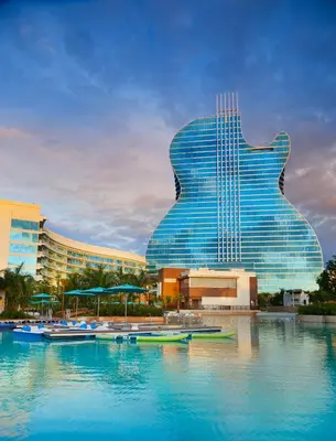 a large guitar shaped building with boats in the water at The Guitar Hotel at Seminole Hard Rock Hotel & Casino in Fort Lauderdale
