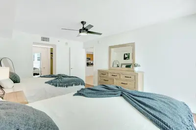 a bedroom with two beds and a mirror at Beautiful Apartments in Miami Brickell in Miami