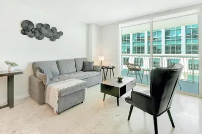 a living room with a couch and a chair at Beautiful Apartments in Miami Brickell in Miami