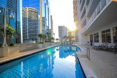 a large swimming pool in a city with tall buildings at Beautiful Apartments in Miami Brickell in Miami