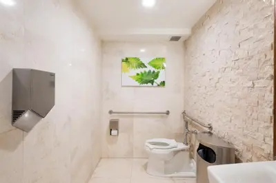 a bathroom with a toilet and a sink at President Hotel in Miami Beach