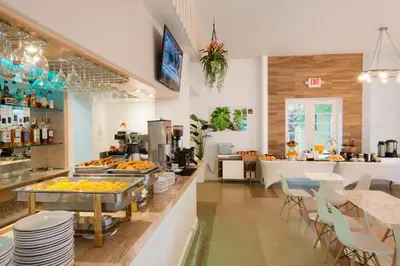 a restaurant with a counter with food on it at Penguin Hotel in Miami Beach