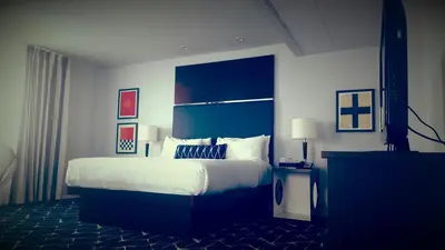 a bedroom with a large bed with a blue headboard at Albion Hotel in Miami Beach