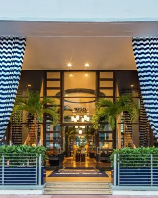 a building with palm trees in front of it at Albion Hotel in Miami Beach