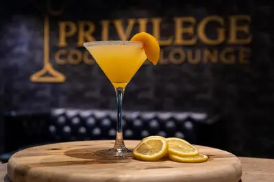a glass of orange juice and two lemons on a table at Albion Hotel in Miami Beach