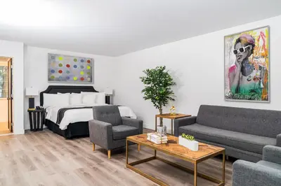 a living room with a bed and a couch at Essex House Hotel in Miami Beach