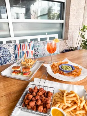 a table with three plates of food and french fries at Circa 39 Miami Beach in Miami Beach