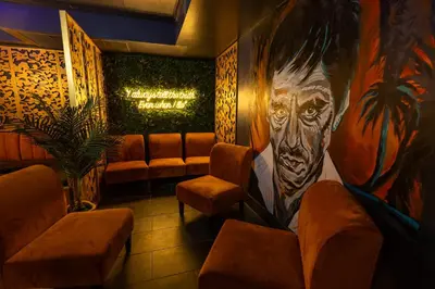 a room with a large painting of a man on the wall at Colony Hotel in Miami Beach