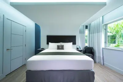 a bedroom with a large bed and a window at Kent Hotel in Miami Beach