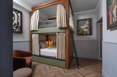 a room with a bunk bed with a mirror at Balfour Miami Beach, a Registry Collection Hotel in Miami Beach
