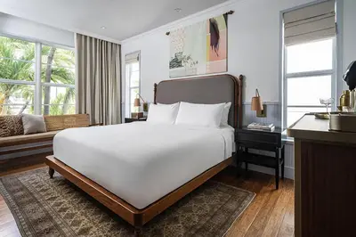 a bedroom with a large white bed and a desk at Balfour Miami Beach, a Registry Collection Hotel in Miami Beach
