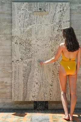 a woman in a yellow bikini standing in front of a wall at Balfour Miami Beach, a Registry Collection Hotel in Miami Beach
