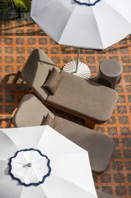 a group of chairs with umbrellas on the floor at Balfour Miami Beach, a Registry Collection Hotel in Miami Beach