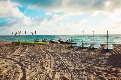 a group of kayaks on a beach near the ocean at Aqua Hotel & Suites in Miami Beach