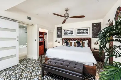 a bedroom with a bed and a couch at National Hotel, An Adult Only Oceanfront Resort in Miami Beach