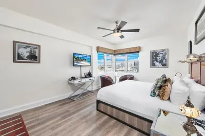a bedroom with a bed and a desk at National Hotel, An Adult Only Oceanfront Resort in Miami Beach