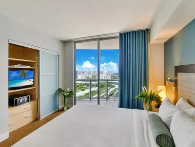 a bedroom with a large bed and a large window at Marenas Beach Resort in Miami Beach