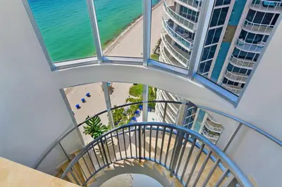 an overhead view of a spiral staircase with a beach and buildings at Marenas Beach Resort in Miami Beach