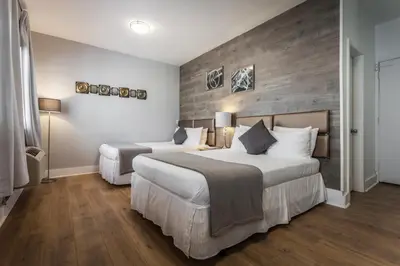 a bedroom with two beds and a wooden wall at Century Hotel in Miami Beach