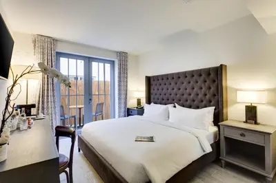 a hotel room with a large bed and a desk at Clinton Hotel South Beach in Miami Beach