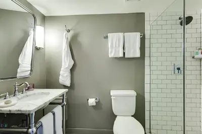 a bathroom with a toilet and a sink and a shower at Clinton Hotel South Beach in Miami Beach