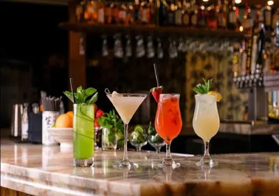 a group of four cocktails sitting on a bar at Clinton Hotel South Beach in Miami Beach