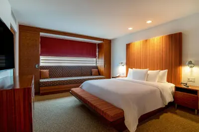 a bedroom with a large white bed and a couch at The Tony Hotel South Beach in Miami Beach
