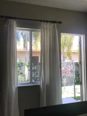 a window with white curtains in a room at Yuli's Home in Miami