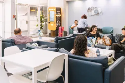 a group of people sitting in chairs in a waiting room at Lorraine Hotel in Miami Beach