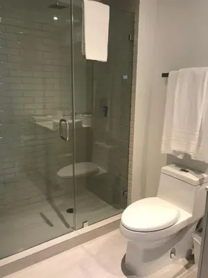 a bathroom with a toilet and a glass shower at Hide House in Hollywood