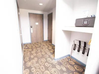 a room with a hallway with a door and a floor at Regency Miami Airport by Sonesta in Miami