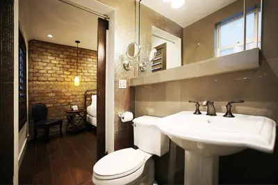 a bathroom with a white sink and a toilet at Cavalier South Beach Hotel in Miami Beach