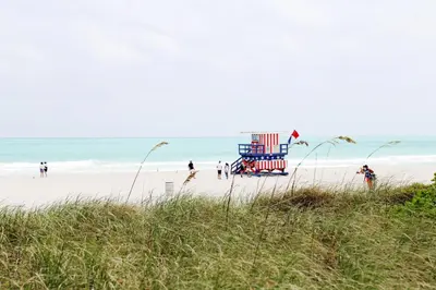 a lifeguard tower on a beach with people on it at Cavalier South Beach Hotel in Miami Beach
