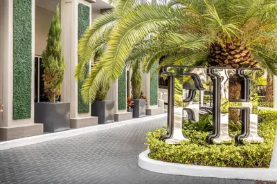 a courtyard with a palm tree in a building at Fortune House Hotel Suites in Miami