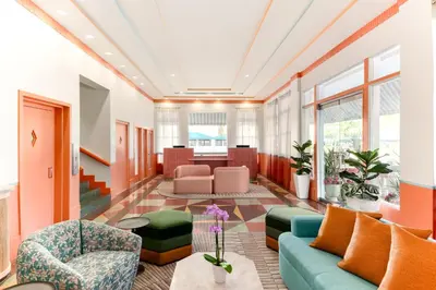a living room with a couch and chairs at Waldorf Towers South Beach in Miami Beach