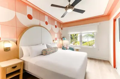 a bedroom with a white bed and a ceiling fan at Waldorf Towers South Beach in Miami Beach