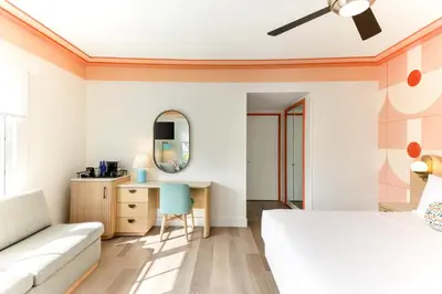 a bedroom with a bed and a desk at Waldorf Towers South Beach in Miami Beach