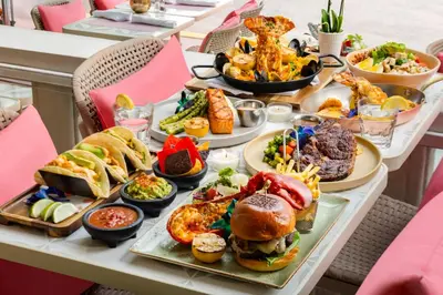 a table topped with plates of food and bowls of food at Waldorf Towers South Beach in Miami Beach