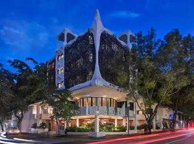 a building on a city street at night at Mayfair House Hotel & Garden in Miami