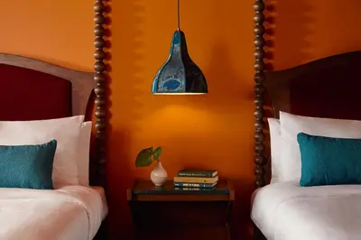 a bedroom with two beds and a pendant light at Mayfair House Hotel & Garden in Miami
