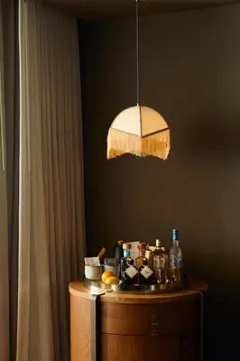 a light hanging over a wooden table with a tableablishthritisthritisthritisthritisthritis at Mayfair House Hotel & Garden in Miami
