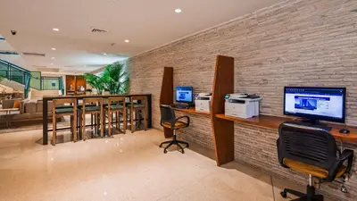 an office with a brick wall with a computer on a desk at Best Western Plus Atlantic Beach Resort in Miami Beach
